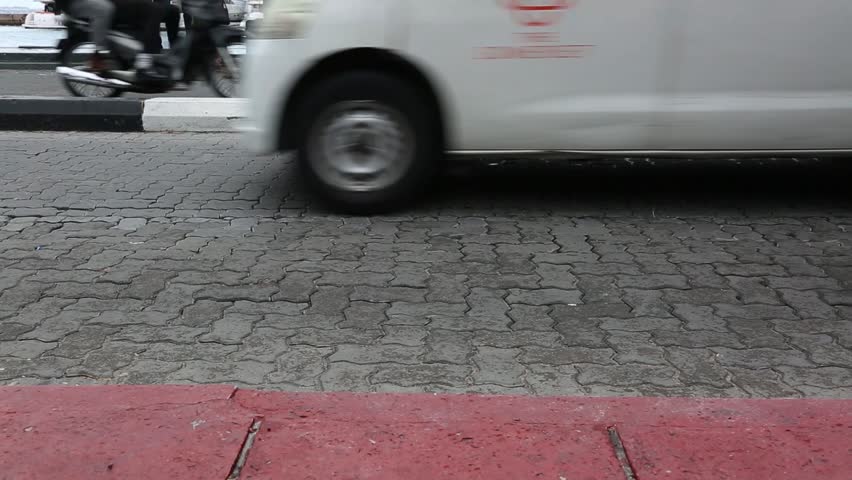 Busy traffic on city road of Malé,Maldives. Cars, bicycles, motorcycles, people are in a hurry somewhere. Busy city life.