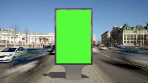Street billboard stand with green screen on safety island with time lapse traffic. Seamless loop.