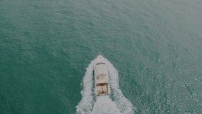 Top view of a white yacht. 4K cinematic video from drone