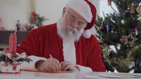 Santa writes letter and put it in envelope