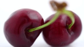 Fresh ripe Cherry close-up. Rotated Organic red cherries isolated on white background. Berries rotation. 4K UHD video