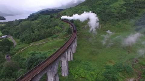 Glenfinnan - May, 2016: Aerial view of the Jacobite crossing Glenfinnan Viaduct in Scotland