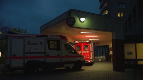 2 ambulances in front of hopsital pan to broken mirror. May, 2017 Berlin, Germany