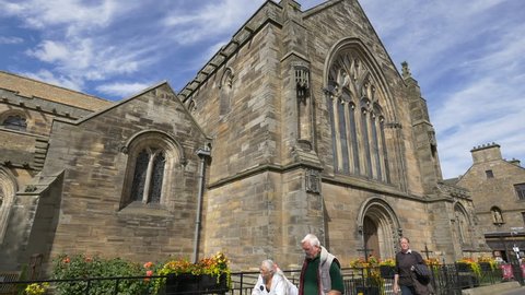 Saint Andrews, United Kingdom - May, 2016: People by the Holy trinity Church in St Andrews, Scotland