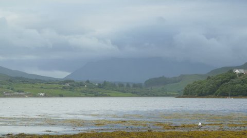Isle of Skye, United Kingdom - May, 2016: Natural scenery of a lake and houses surrounding it