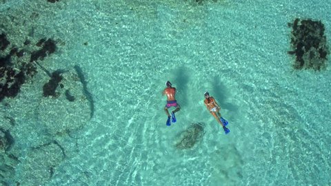 Couple Snorkeling In Shallow Turquoise Water