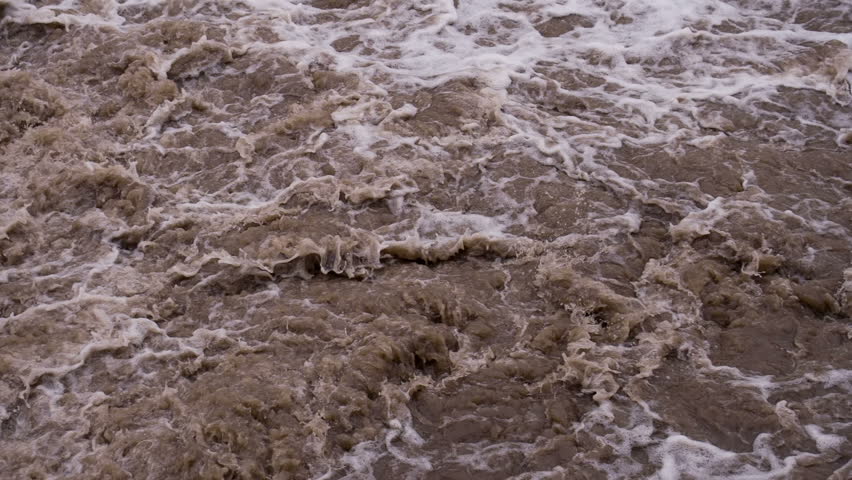 Получите стоковое видео "Bubbling Mud Flow Powerful Streams Dirty"...