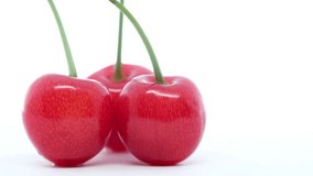 Rotating cherry fruits on isolated white background