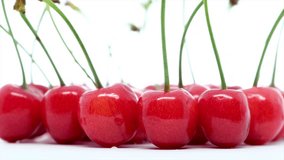 Rotating cherry fruits on isolated white background