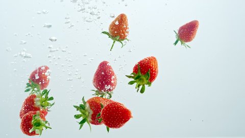 the strawberry falls into the water. Slow Motion Picture