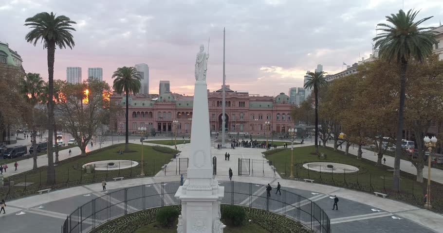 Aerial Drone Scene of May Square and Casa Rosada. The camera travels upwards with the sunset. Landscape of the pyramid and pink house, historic building. Buenos Aires, Argentina