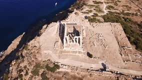 Aerial drone bird's eye view video of iconic archaeological site of Cape Sounio, Ancient temple of Poseidon, Attica, Greece