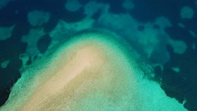 Aerial drone bird's eye view video of tropical caribbean island forming atoll with beautiful turquoise and sapphire clear waters