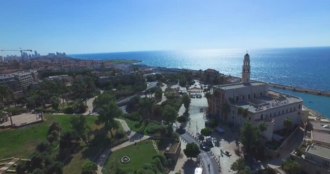 Tel Aviv - Jaffa / Aerial Drone footage. Fly from saint peter's church in Jaffa to Tel Aviv beaches and Skyline cityscape