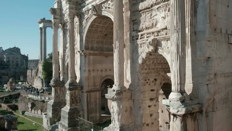 Detailed carvings and reliefs visible in camera tilt up close-up bottom to top view of the Arch of Septimius Severus in the Roman Forum in Rome, Italy. 4K UHD at 29.97fps