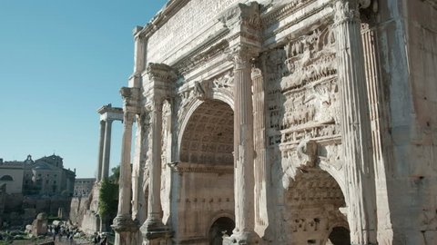 Detailed carvings and reliefs visible in camera tilt down close-up top to bottom view of the Arch of Septimius Severus in the Roman Forum in Rome, Italy. 4K UHD at 29.97fps