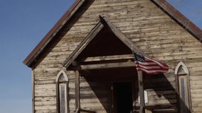 Old west church full speed american flag in wind - Powered by Shutterstock - Get 15% off with code: PIKWIZARD15