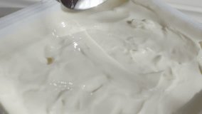 Cream cheese taking with metallic spoon slow motion video