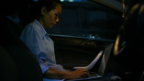 Woman with a laptop in her car