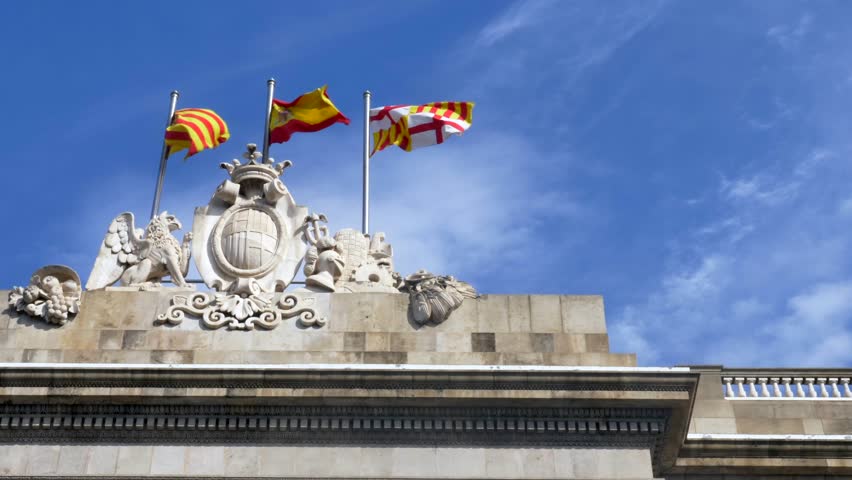 Waving Flags of Catalonia, Spain and Barcelona on top of Barcelona