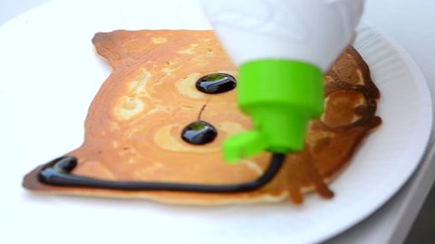 Baked pancake made on food 3d printer and poured chocolate. 3D printer for liquid dough. 3D printer printing pancakes with liquid dough different shapes close-up. Modern additive food technologies 库存视频