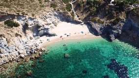 Aerial drone bird's eye view video of famous clear water rocky beach of KAPE in area of Legrena, Sounio, Attica, Greece