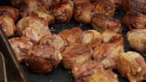 Delicious chicken and bacon balls cooking on BBQ