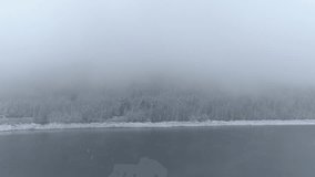 Flying camera aerial over a lake in winter
