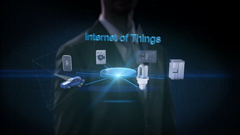 Businessman touching 'Internet of things' connecting mobile, car, energy saving, washer, refrigerator, smart home devices, 4k