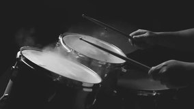 Dust from drum set with a man sitting in low light background, Cinemagraph. 