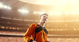 Goalkeeper celebrates a victory and raises arms happily on the professional stadium while the sun shines. Stadium and crowd are made in 3D and animated.