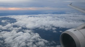 View of the sky above cloud level from the cabin window of airplane (plane) while flying in the sky with some cloud (watch through cabin plane window) -4K UHD video movie footage short