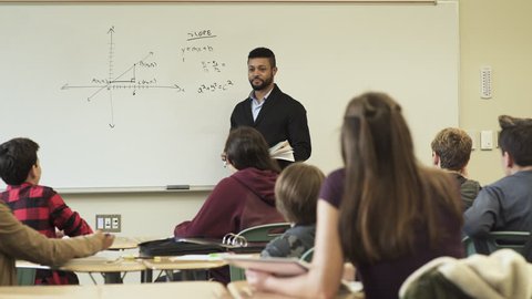 Medium shot of teacher holding math class