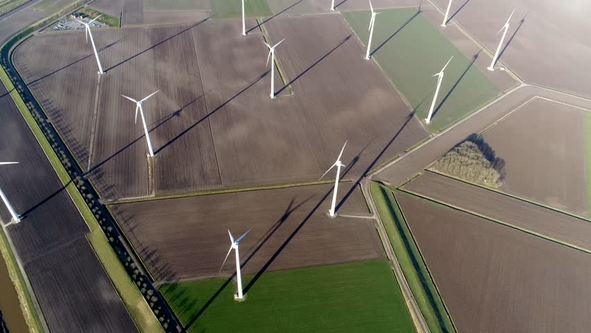 Aerial top down footage of wind farm a group of wind turbines in the same location used to produce electricity pruducing sustainable renewable energy provided by national recources 4k quality Royalty-Free Stock Footage #1011994178