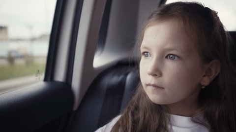 A little blond girl looking out of a car window, Stock video footage 8202