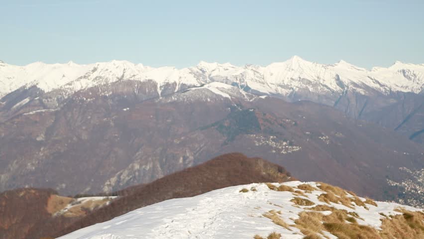 Woman walking uphill with snowshoes
