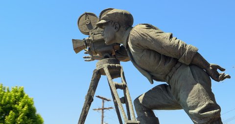 LOS ANGELES, CALIFORNIA, USA - JUNE 3, 2018: Bronze sculpture of the Hollywood cameraman near Warner Brothers Pictures Studios in Burbank, Los Angeles, California, 4K