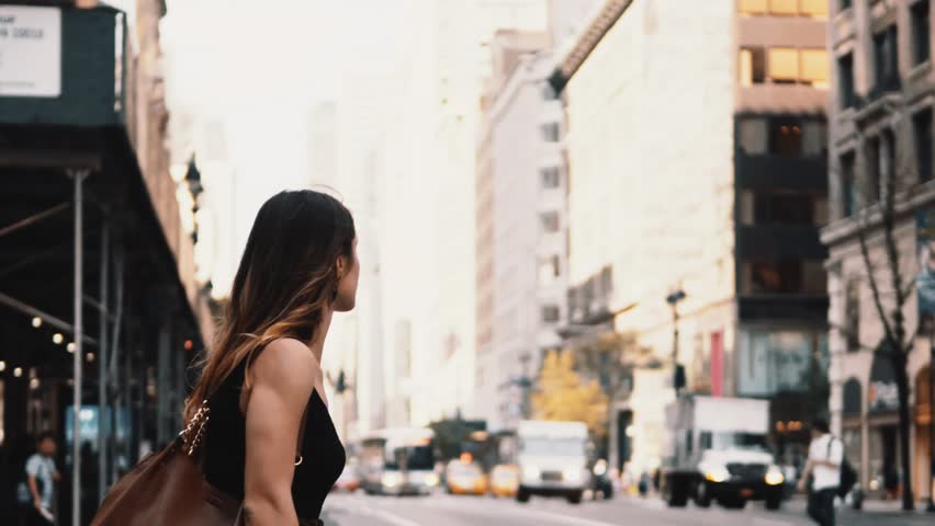 Young beautiful woman crossing the road in traffic downtown of New York, America. Female walking through the crosswalk. Royalty-Free Stock Footage #1012012190