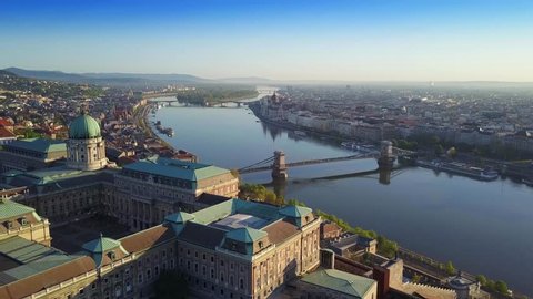 Budapest, Hungary - 4K Aerial skyline view of Budapest with Buda Castle Royal Palace, Szechenyi Chain Bridge and River Danube at sunrise