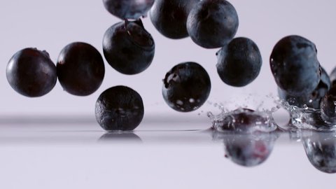 Super slow motion of falling blueberries into water. Filmed on cinema slow motion camera, 1000fps, ProRes 422 HQ codec.
