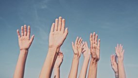 People rasing hands on blue sky background. Voting, democracy or volunteering concept - Powered by Shutterstock - Get 15% off with code: PIKWIZARD15