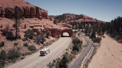 The drone follows a camper in Bryce on a sunny day with a clear blue sky in the USA Aerial Drone Footage 4K