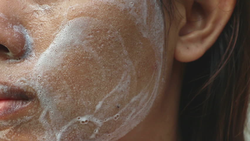 Close up Asia woman cheek. Woman washing face (have wide pores) with white foam by her hand. | Shutterstock HD Video #1012029605
