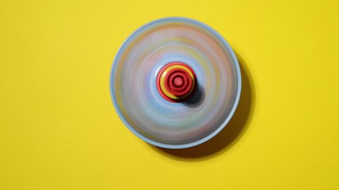 spinning top for children in action on a yellow background