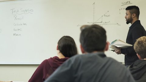Medium shot of teacher holding math class
