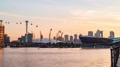 8k timelapse of cable cars in the dockland district in London at sunset, transition to night