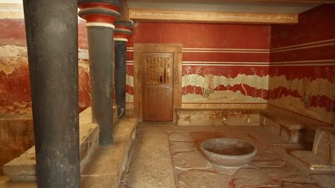 The Throne Room in the Minoan Palace of Knossos, Heraklion, Crete, Greece flanked by a beautiful Griffin couchant fresco. Knossos is the largest Bronze Age archaeological site in Crete.