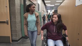 Medium shot of two friends chatting on school corridor - Powered by Shutterstock - Get 15% off with code: PIKWIZARD15