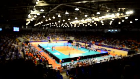 Blurry video of volleyball game in indoor stadium