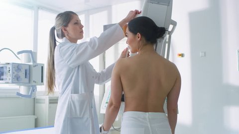 In the Hospital, Female Patients Undergoes Mammogram Screening Procedure Done by Mammography Technologist. Modern Technologically Advanced Clinic with Professional Doctors.  Shot on RED EPIC-W 8K.